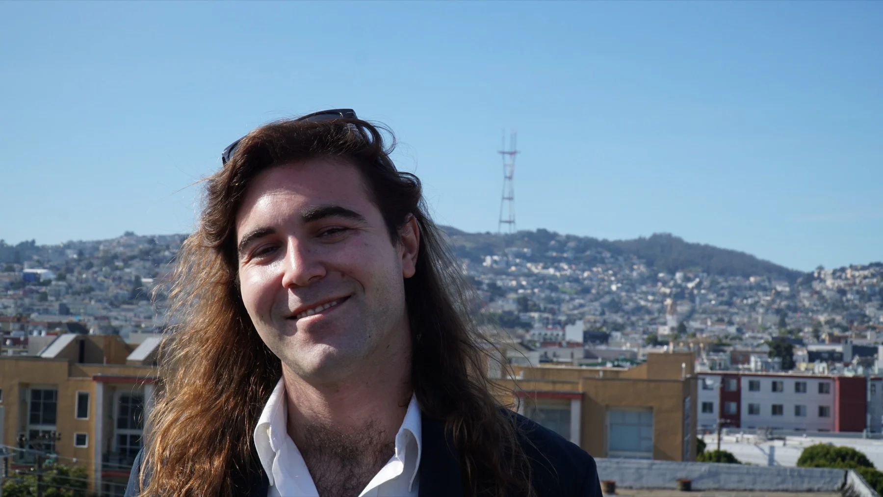 Aaron Cundy outdoors with the San Francisco skyline behind him